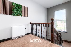 a room with a staircase with a plant on the wall at Bright and Warm Studio Apartment in Derby by Renzo, Brilliant Location, Free Parking! in Derby