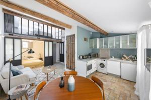 a kitchen and living room with a table and a couch at Joli duplex climatisé/Wifi 2 chambres centre Aix in Aix-en-Provence