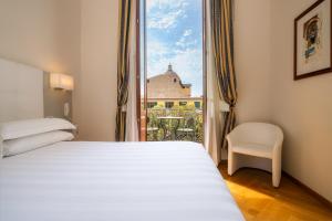 Postel nebo postele na pokoji v ubytování Hotel Croce Di Malta
