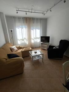 a living room with a couch and a coffee table at Apartamento El Pilar in Güéjar-Sierra