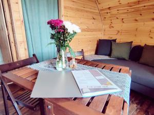 a table with a vase of flowers on it at Saints' Meadow in Crich