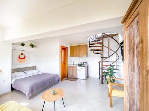 a bedroom with a bed and a spiral staircase at Studio Acropolis Serres Next to Center in Serres