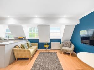 a living room with a couch and two chairs at Serene 2BR Retreat in Bishop's Stortford in Bishops Stortford