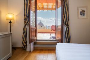 Postel nebo postele na pokoji v ubytování Hotel Croce Di Malta
