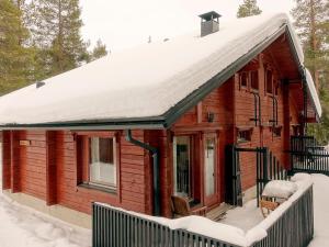 a log cabin with snow on the roof at Holiday Home Rovarakka 1 a by Interhome in Levi