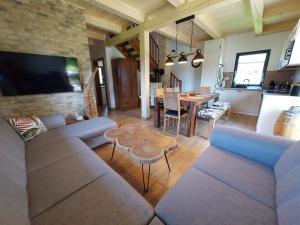 a living room with a couch and a table at CHALUPY TRI GROŠE VLAŠKY in Bešeňová