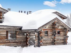 a log cabin covered in snow at Holiday Home Kantapää c 3 by Interhome in Luosto