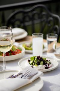 a table with plates of food and a glass of wine at Marlo Ayvalık 12 Plus Adult Only in Ayvalık +138 photos