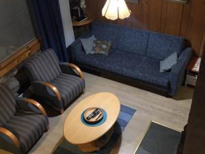 a living room with a couch and a table at Holiday Home Vuokatinportti b 8 by Interhome in Vuokatti