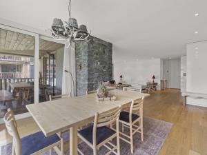 a dining room with a wooden table and chairs at Apartment Triangel Raber by Interhome in Parpan