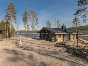 a log cabin sitting on the side of a road at Holiday Home Villa moose by Interhome in Jukara