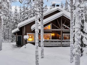 a log cabin in the snow with trees at Holiday Home Ansa by Interhome in Sirkka