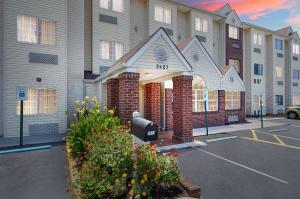 a building with a parking lot in front of it at Microtel Inn and Suites by Wyndham - Cordova in Memphis