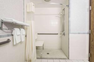 a bathroom with a shower with a sink and a toilet at Days Inn by Wyndham Berlin Meriden in Berlin