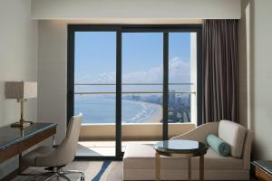 a living room with a view of the ocean at Four Points by Sheraton Danang in Da Nang