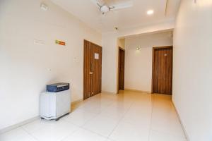 an empty room with a hallway with two doors at FabHotel Royal Hospitality in Pune