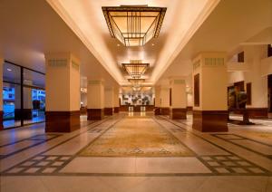 a hallway with a large lobby with a rug on the floor at Hyatt Regency Kinabalu in Kota Kinabalu