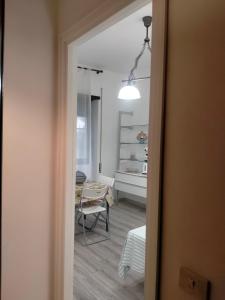a view of a room with a table and a mirror at Setta Apartment in Lido di Ostia