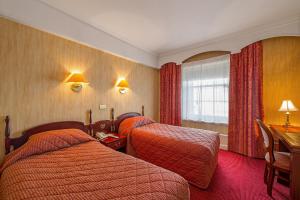 Letto o letti in una camera di Wynn's Hotel