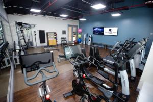 a gym with several treadmills and cardio machines at DoubleTree Suites by Hilton Hotel & Conference Center Chicago-Downers Grove in Downers Grove