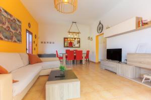 uma sala de estar com um sofá e uma mesa em Villa Roby Corralejo em La Oliva