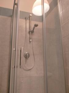 a shower with a glass door in a bathroom at Setta Apartment in Lido di Ostia +6 photos