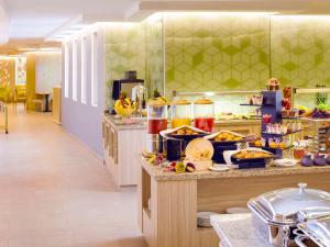 a kitchen with a buffet with food on a counter at ibis Styles Makkah in Mecca