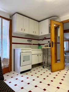 a kitchen with white cabinets and a stove at Cozy Chalet With Mountain Views in Ussin, Valtourneche, Parking in Chamois