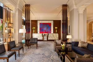 a lobby with couches and chairs and a painting at The Ritz-Carlton, Budapest in Budapest