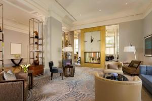 a living room with a couch and a clock at The Ritz-Carlton, Budapest in Budapest