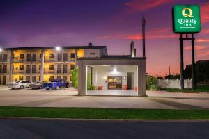 a building with a parking lot in front of it at Quality Inn Tulsa Central in Tulsa