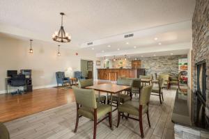 a dining room and living room with a table and chairs at Quality Inn Tulsa Central in Tulsa