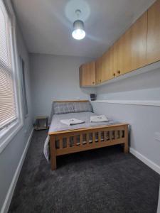 a room with a bed and a table in it at 1B Smart Apartments in Newark-on-Trent