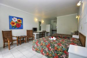 Habitación con cama, mesa y cocina. en Kosrae Nautilus Resort, en Yepan