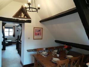 a dining room with a wooden table and chairs at Penybont Barn in Llangorse