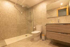 a bathroom with a toilet and a shower and a sink at Luxury apartment in Miraflores in La Cala de Mijas +17 photos