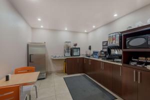a room with a kitchen with a microwave and a refrigerator at SureStay Hotel by Best Western Williams - Grand Canyon in Williams