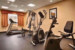 a gym with several exercise bikes in a room at Days Inn & Suites by Wyndham Sam Houston Tollway in Houston
