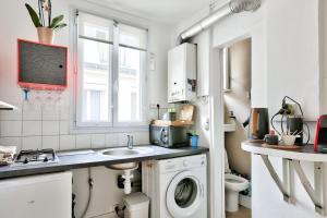 a kitchen with a sink and a washing machine at Bright studio just a stone's throw from the Bataclan in Paris