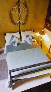 a bedroom with a large bed with white sheets at Casa da Floresta entre Paraty e Ubatuba in Ubatuba