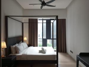 a bedroom with a bed and a ceiling fan at KLCC Beyond Hospitality Suites STAR in Kuala Lumpur