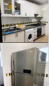 a kitchen with white cabinets and a stainless steel refrigerator at Appartement à résidence Ap8 , marina , saidia in Berkawe