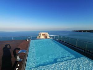 a swimming pool with a view of the ocean at Cavour 19 - Dependance in Torre dell'Orso