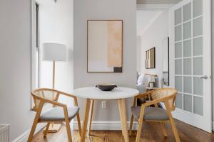 a dining room with a white table and two chairs at East Village 2br w wd nr groceries shops NYC-1235 in New York