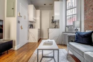 a living room with a couch and a table at Nolita 1br w wd nr shopping groceries NYC-1220 in New York