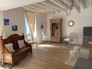 a living room with a couch and chairs at Domaine de Cachaou Villa Leyr'ial sauna & spa in Salles