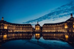 a large building with its reflection in the water at night at Domaine de Cachaou Villa Leyr'ial sauna & spa in Salles