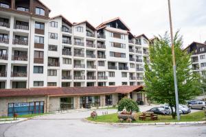 a large apartment building with a park in front of it at All Seasons Apartments Borovets Gardens in Borovets