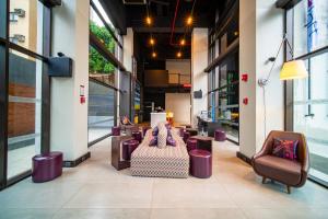 a lobby of a building with chairs and a couch at Aloft Asuncion in Asuncion