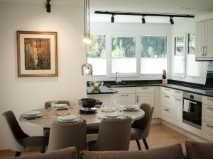 a kitchen with a dining room table and chairs at Apartment Davinci by Interhome in Täsch